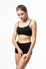 Fototapeta premium Fitness woman with a beautiful body in black lingerie isolated on white background