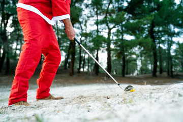 Santa Claus practicing his golf swing