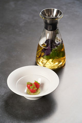 Fresh peeled chili tomatoes and minced cucumbers on dark background with copy space