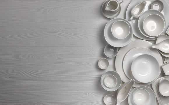 Set of empty dishware on white background with copy space