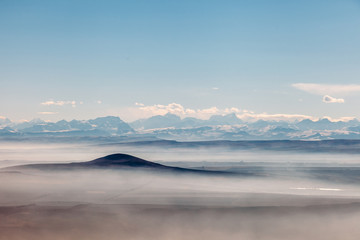 aerial view on a mountains covered clouds from the plane