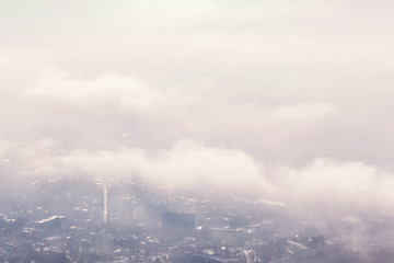 Fototapeta premium aerial view of the city through the clouds