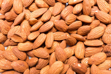 Whole almond nuts background. Vegetarian healthy snack. Organic food. Vegetable diet.