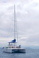 Leisure sail catamaran anchored off the coast of Phuket, Thailand.