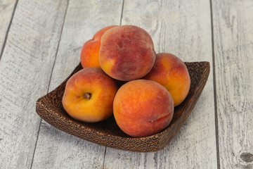 Peach heap in the wooden basket