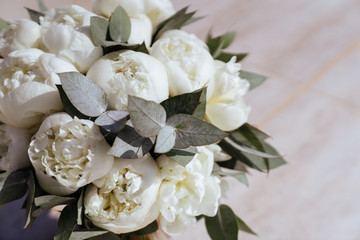 Close-up image of a beautiful and stylish wedding bouquet of white and pink peonies. Summer floral composition.