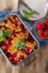 Yeast cake with strawberry in a mold.