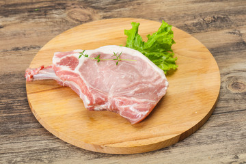 Raw pork bone steak over wooden