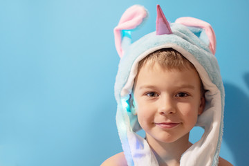 a boy in a trendy glowing hat with rising ears in the shape of a unicorn