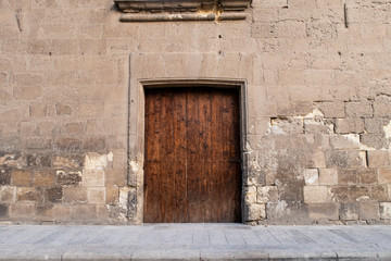 Fototapeta na wymiar old wooden door in wall bricks 