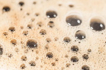 Air bubble foam formed on freshly flavored black coffee.
