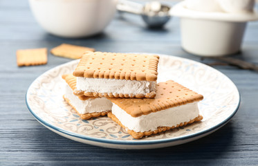 Fototapeta na wymiar Sweet delicious ice cream cookie sandwiches on blue wooden table