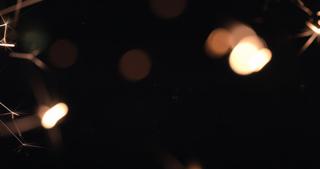 Burning firework sparks on black background, happy Christmas and New year celebration