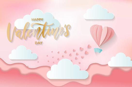 Paper cut hot air heart shaped balloon flying on over the hills and scattering little hearts. Origami digital craft style. illustration of love and Valentine's day with golden lettering greetings