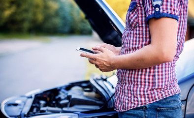 Man calling for help after a car breakdown. Cars and transportation concept