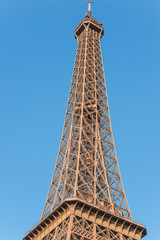 The Eiffel Tower against the blue sky. Close up. Vertical picture