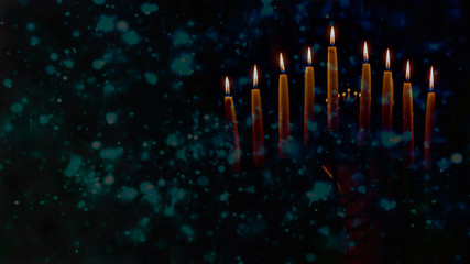 Menorah with lit candles in celebration of Chanukah. A symbolic candle lighting for the Jewish holiday of Hanukkah. The eighth and final night of Hanukkah.