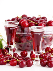 Sour cherry liqueur in glasses and sour cherries