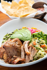 Mexican carnitas and tortilla chips with salsa