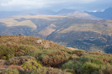 Fototapeta na wymiar Photograph of a road between the mountains of Sierra Nevada, Granada, Spain