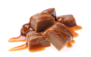 Pieces of caramel with sauce isolated on white