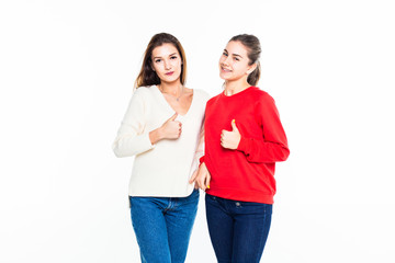 Two teen girl with thumbs up gesture isolated on white background