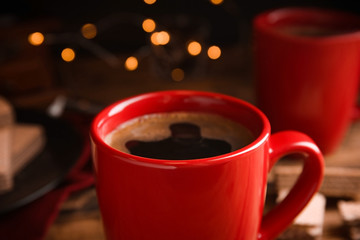 Cup of delicious black coffee on table, closeup