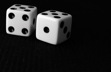 two dice on a black background