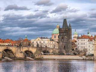 Fototapeta na wymiar Charles Bridge in Autumn Before Rain, Gray-Blue Cloudy Afternoon Weather, Prague - the Capital of the Czech Republic