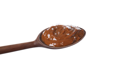 Salted caramel in spoon isolated on white