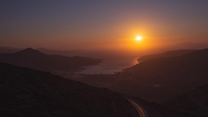 Obraz premium sunset over the bay with the port in Amorgos