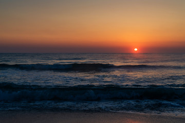 Beautiful sunrise on the sea coast in a storm