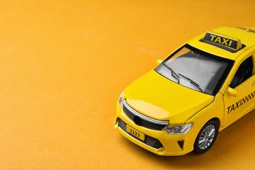 Foto op Plexiglas Yellow taxi car model on orange background. Space for text © New Africa