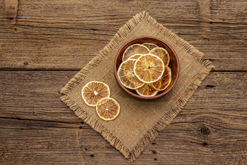 Dried slices of lemon in bowl. Fruit snack, healthy eating concept