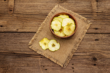 Dried slices of apple in bowl. Fruit snack, healthy eating concept
