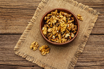 Sprinkled walnuts in ceramic bowl. Natural organic snack, healthy eating concept