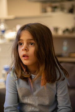 5 years old sweet girl watching TV
