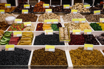 Assortment of delicious dried fruits and nuts at wholesale market
