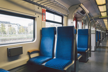 Inside The Wagon Train Germany, Dusseldorf. Empty train interior. interior view of corridor inside passenger trains with blue fabric seats of German railway train system