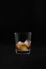 whiskey with ice on a black background