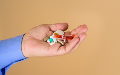 Different pills prescribed by doctor. Medicine pills in hand. Tablets in hand of patient. Medical concept. Hand of man holds different pills. Medicine, treatments and healthcare. Man hands with pills.