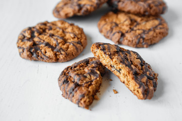 Delicious oatmeal cookies with chocolate on white table background. Copy, empty space for text