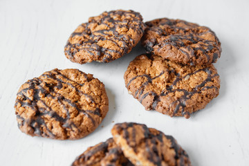 Delicious oatmeal cookies with chocolate on white table background. Copy, empty space for text