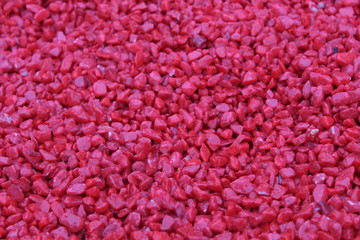 red or maroon background small stone or wood chips