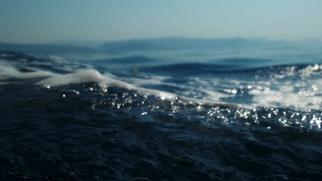 Sea level from moving glass boat. Prores 422 10 Bit slow motion.