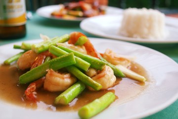 Stir fried shrimp and green beans marinated in sweet and sour sauce, served with steamed rice at a restaurant in Phuket, Thailand.