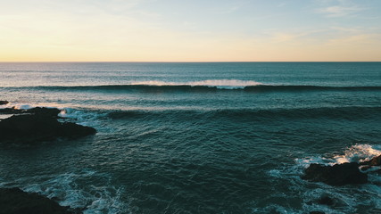 Landscape and sunset on the coast contemplating the breaking of the waves on the cliffs