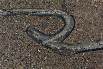Asphalt seam sealant on slightly damp blacktop