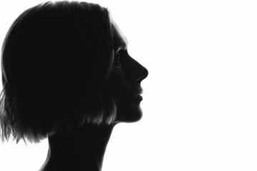 silhouette of women in profile on white background
