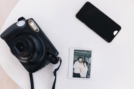 New Year Photo Of Family In Instant Print Lying On A Table